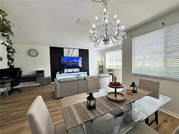 a dining room with wooden floor and a window
