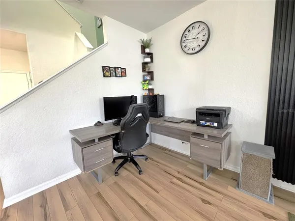 a view of kitchen with stainless steel appliances granite countertop lots of counter top space