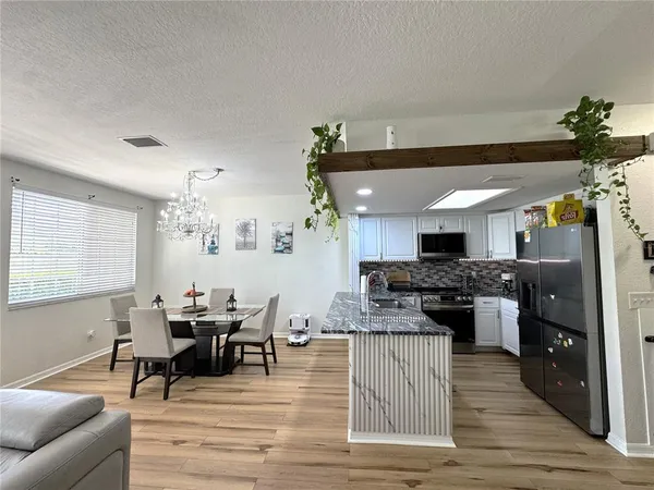 a kitchen with stainless steel appliances granite countertop a stove sink and microwave