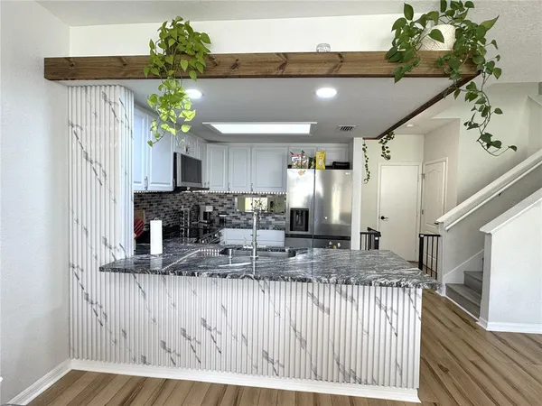 a bedroom with a bed a flat screen tv and a couch