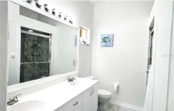 a white toilet sitting next to a bathroom sink