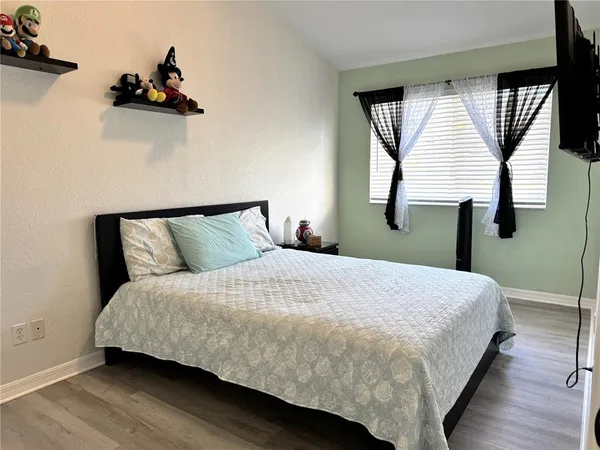 a bed sitting in a bedroom next to a window