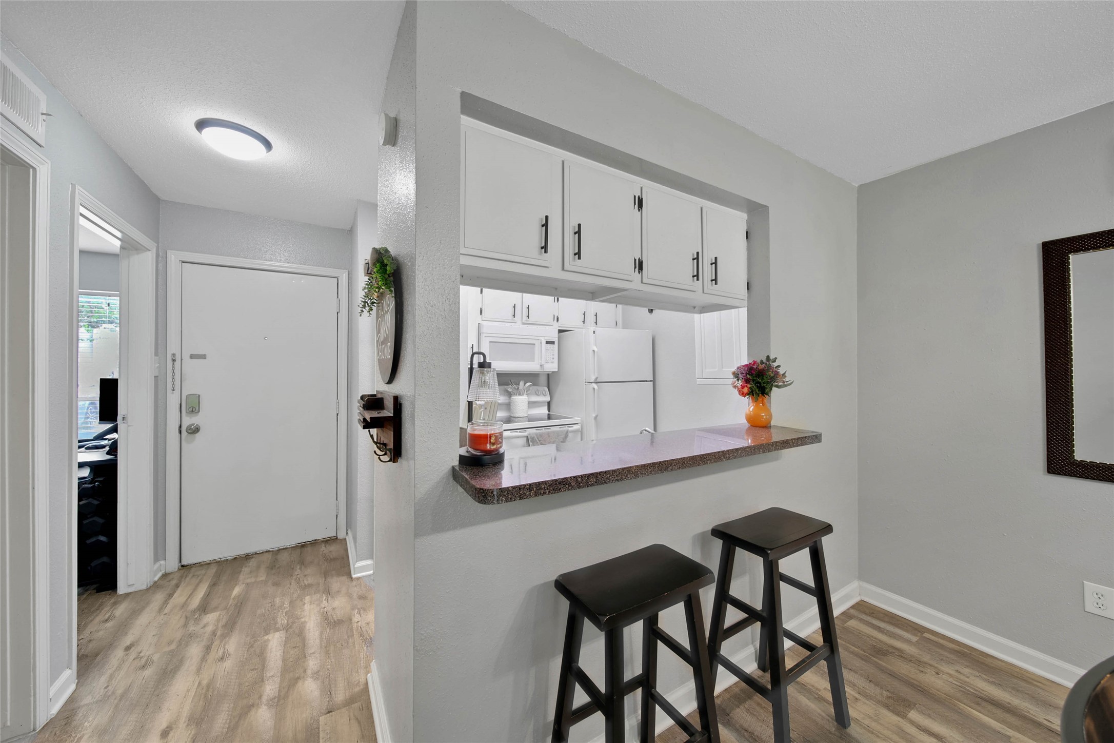 13151 Walden Road, Unit 119 Montgomery, TX 77356 - Photo 11 of 28 This cozy kitchen has white appliances, offering a bright and welcoming space.