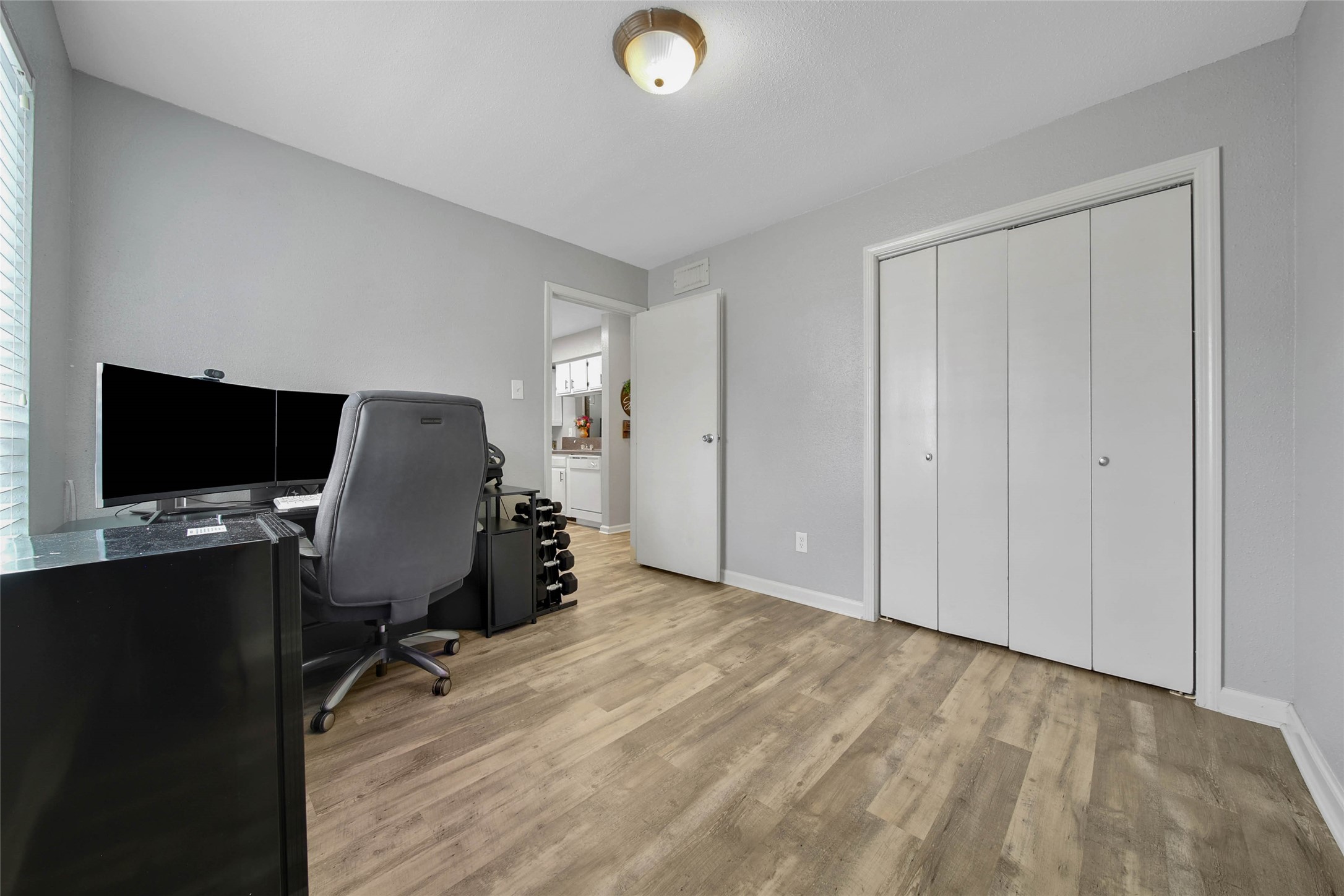 13151 Walden Road, Unit 119 Montgomery, TX 77356 - Photo 17 of 28 Currently serving as a workspace, this secondary bedroom offers a closet, natural lighting from the window making for a great flex space however you may design it!