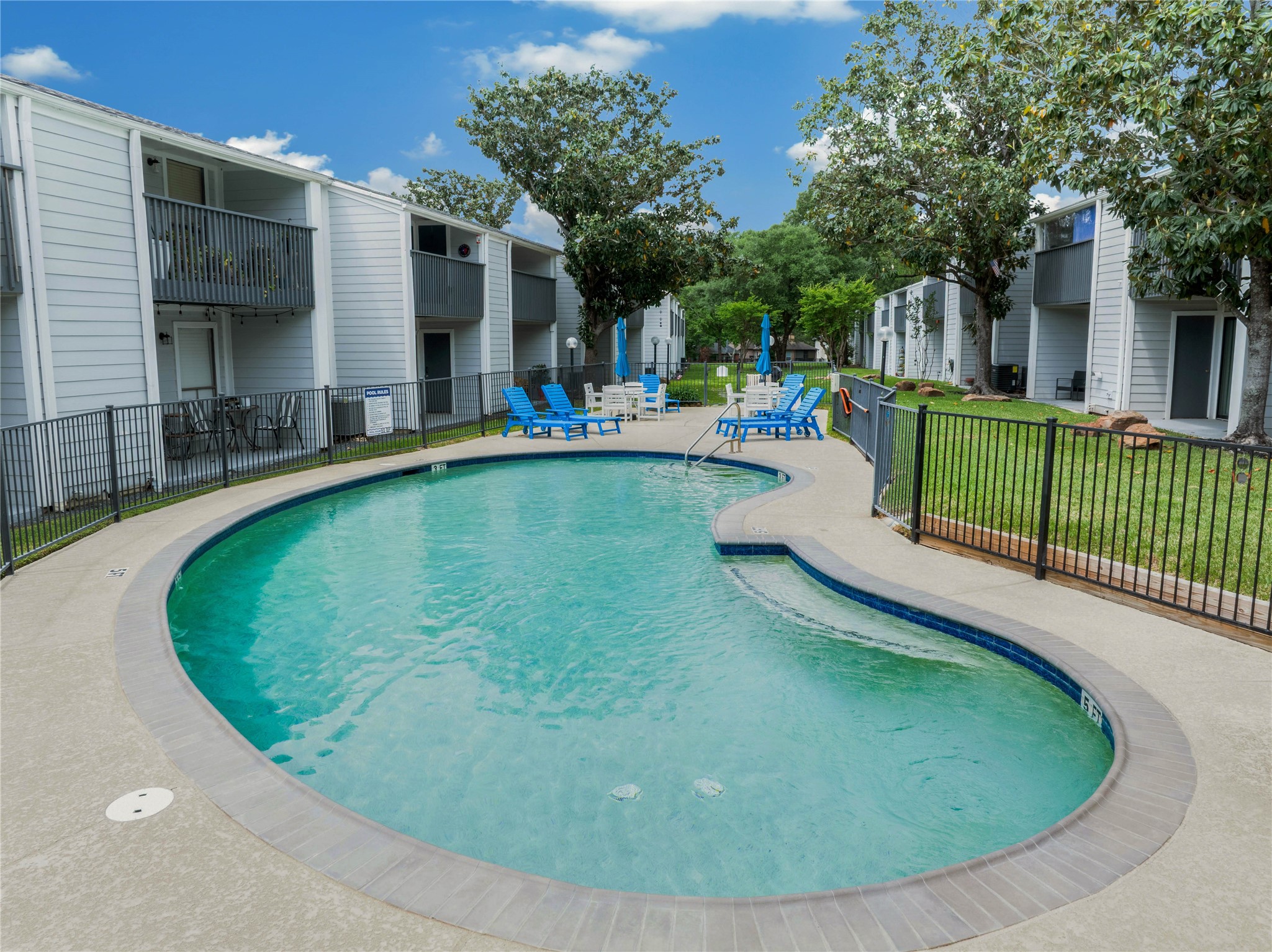 13151 Walden Road, Unit 119 Montgomery, TX 77356 - Photo 6 of 28 Inverness Condos features a well-maintained swimming pool, surrounded by a secure fence. There are patio areas and outdoor seating, providing a relaxing communal space for your enjoyment!