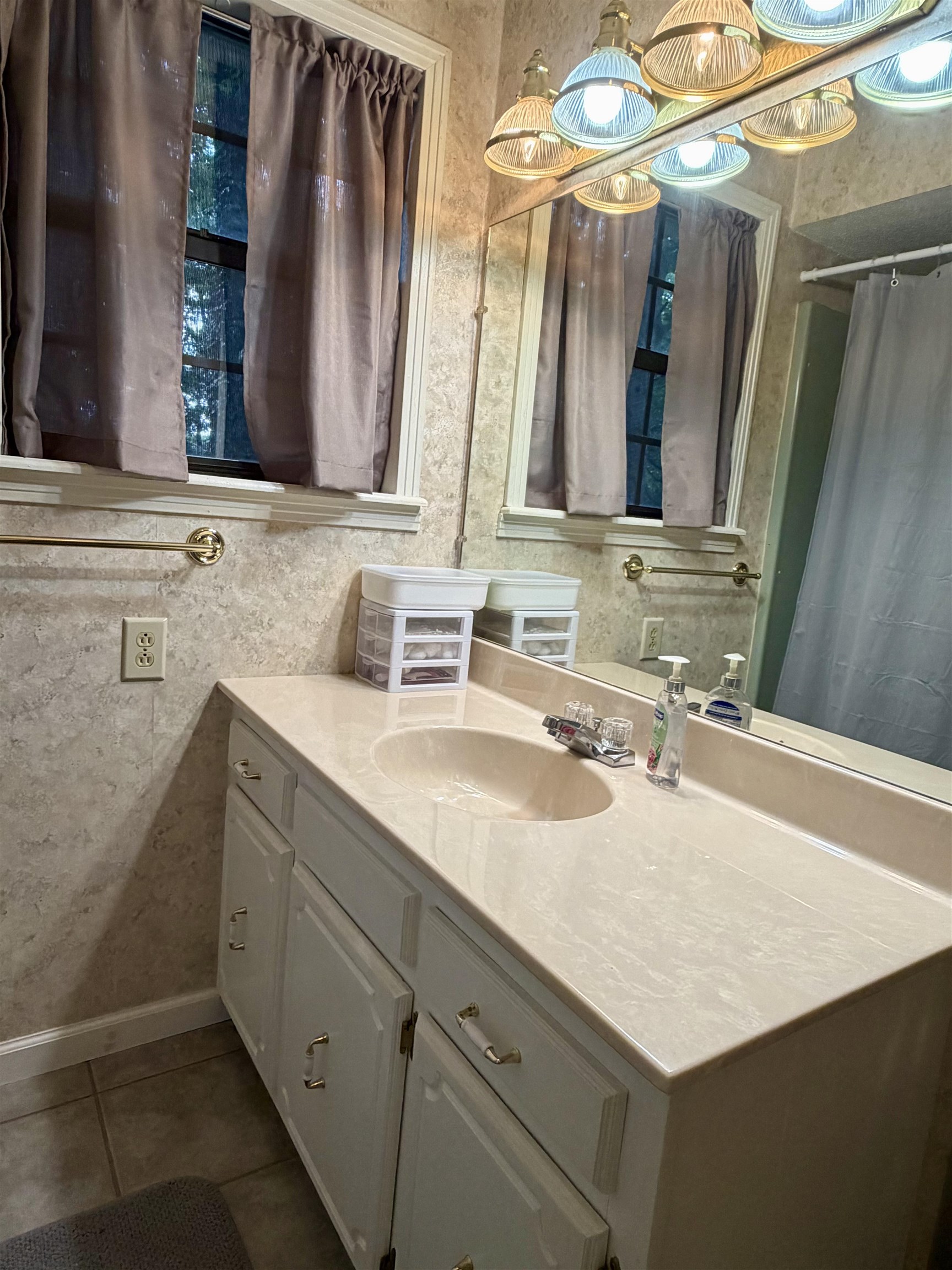 373 Clarence Barham Road Bethel Springs, TN 38315 - Photo 18 of 28 Bathroom vanity featuring an integrated sink, light-toned countertop, and white cabinetry with decorative pulls