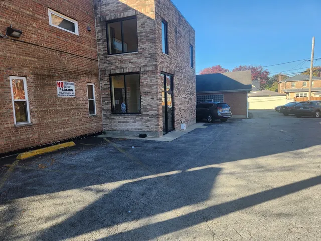 a view of a brick house with many windows