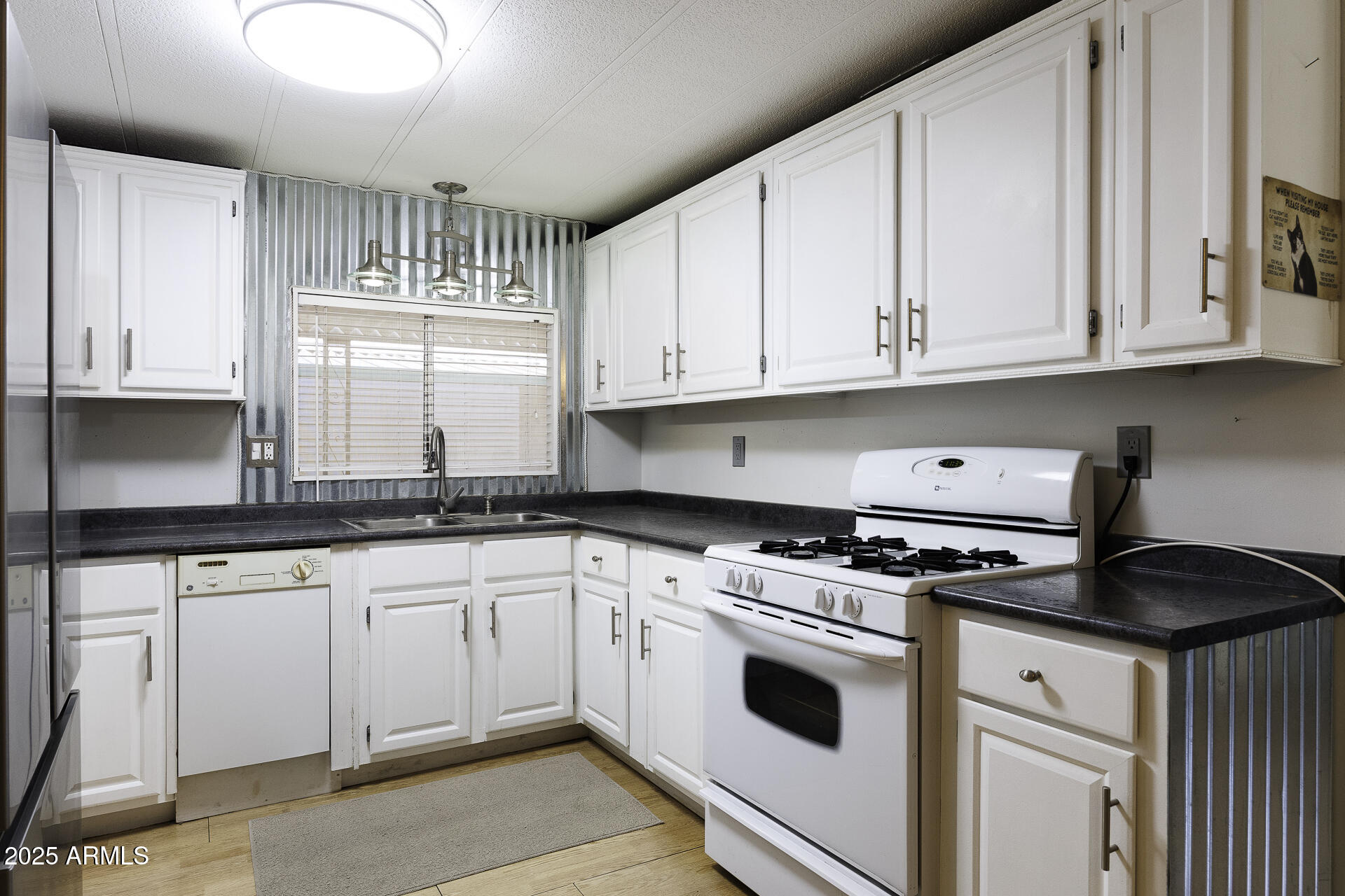2100 North Trekell Road, Unit 20 Casa Grande, AZ 85122 - Photo 7 of 40 a kitchen with granite countertop white cabinets and white appliances