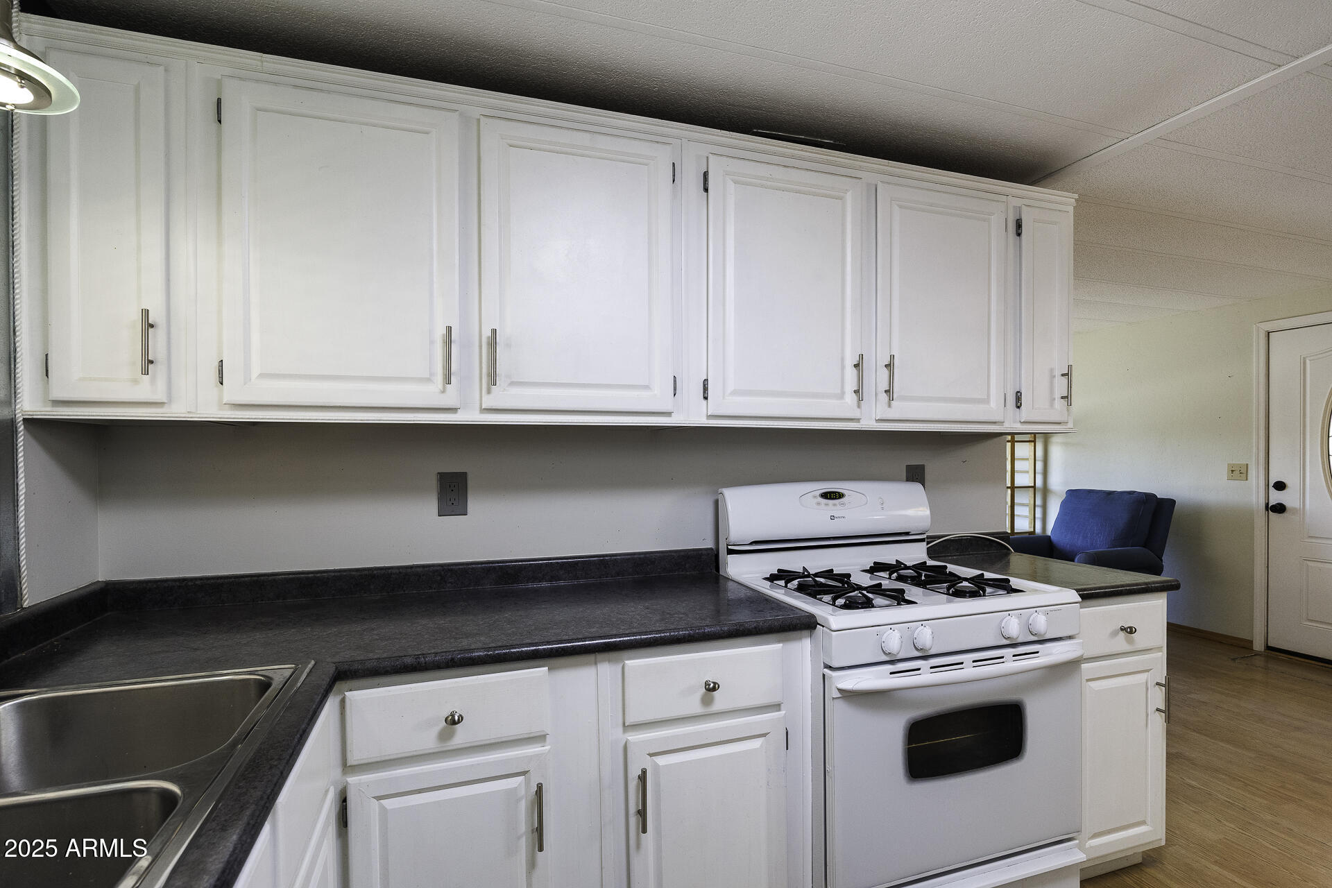 2100 North Trekell Road, Unit 20 Casa Grande, AZ 85122 - Photo 9 of 40 a kitchen with granite countertop white cabinets and white appliances