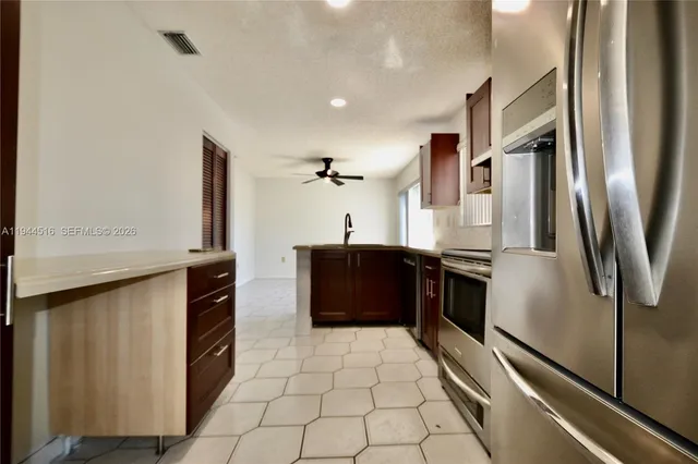 a view of a pathway of a park with large trees