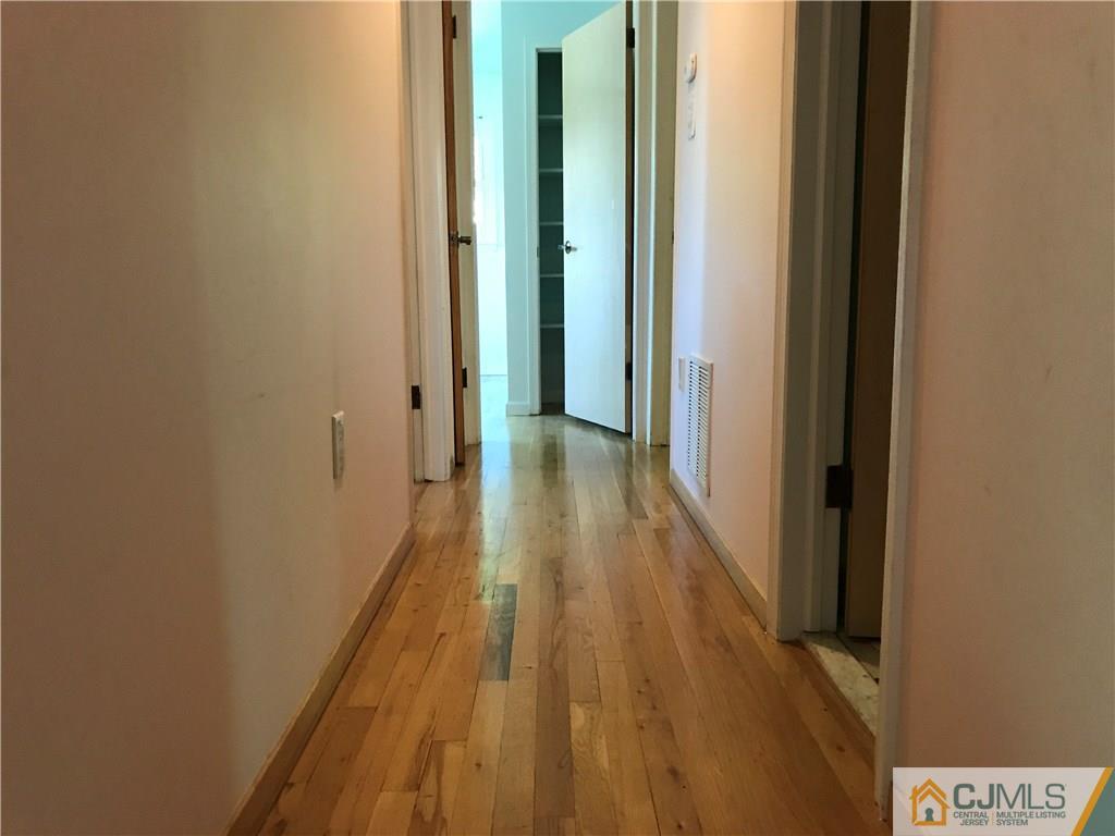 26 Francis Road East Brunswick, NJ 08816 - Photo 12 of 23 a view of a hallway with wooden floor