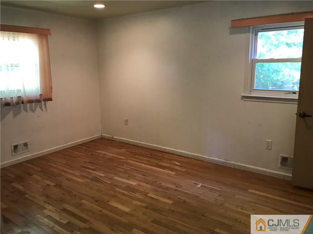 26 Francis Road East Brunswick, NJ 08816 - Photo 13 of 23 an empty room with wooden floor and windows