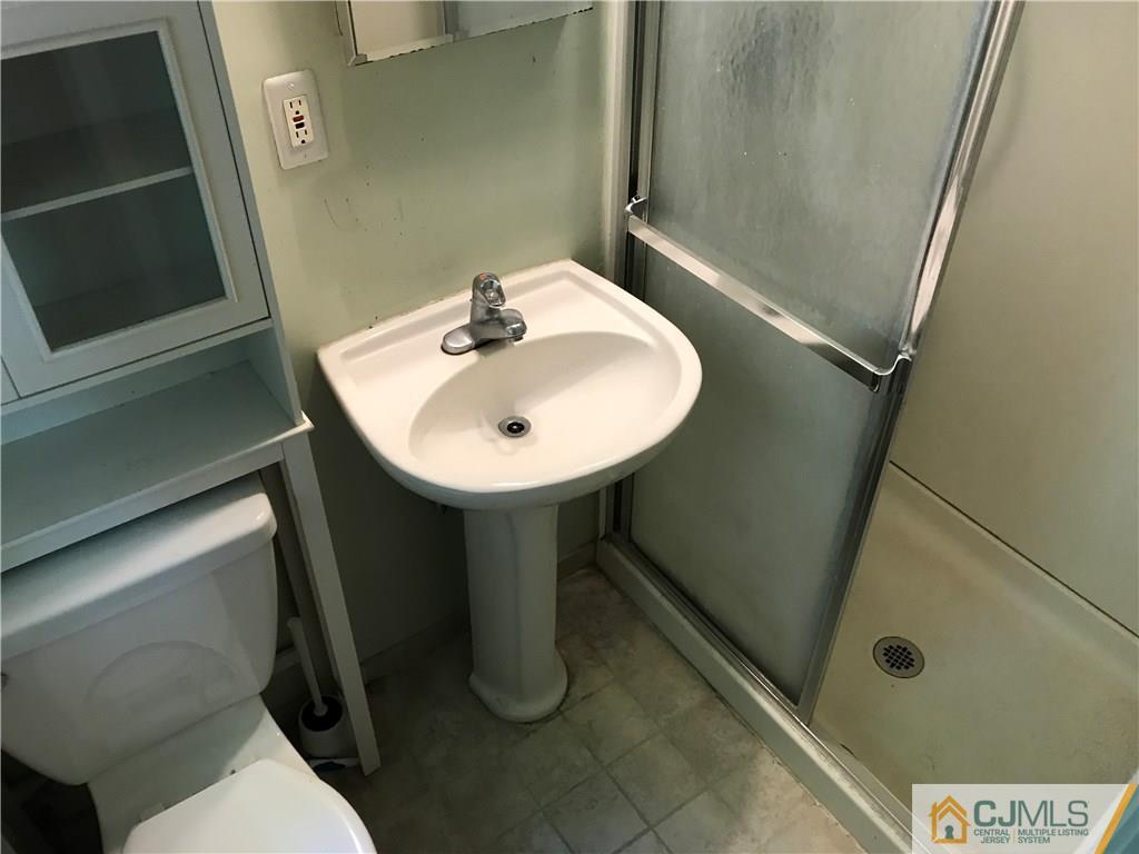 26 Francis Road East Brunswick, NJ 08816 - Photo 17 of 23 a bathroom with a sink a toilet and a mirror