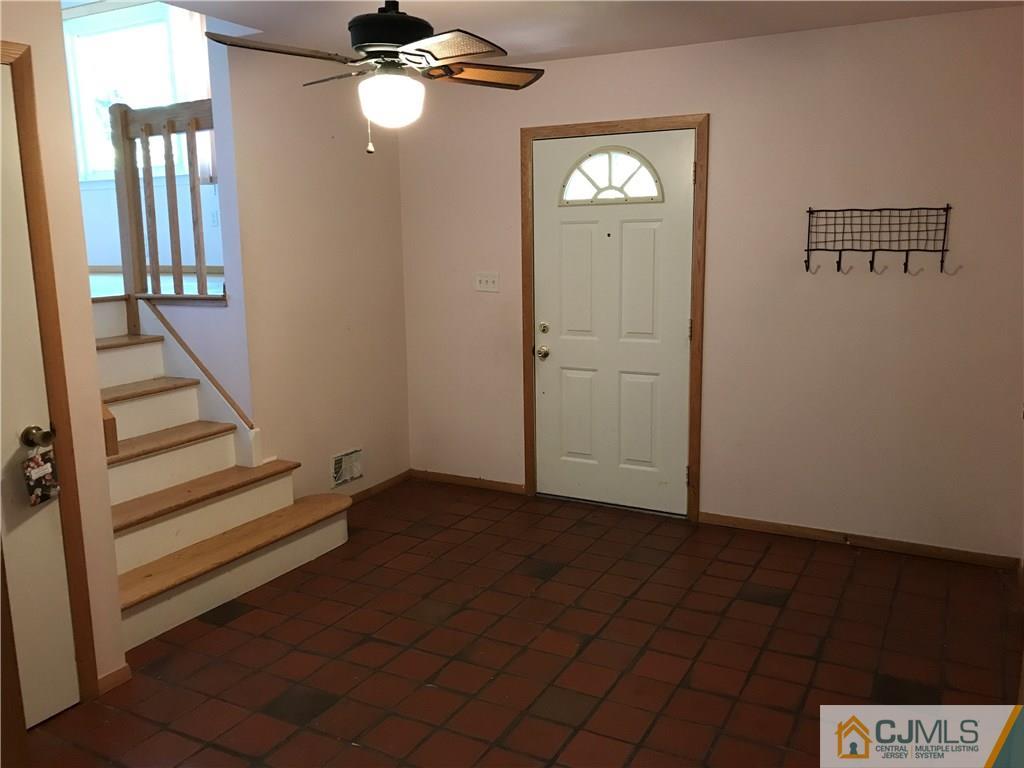 26 Francis Road East Brunswick, NJ 08816 - Photo 3 of 23 wooden floor in an empty room with a window