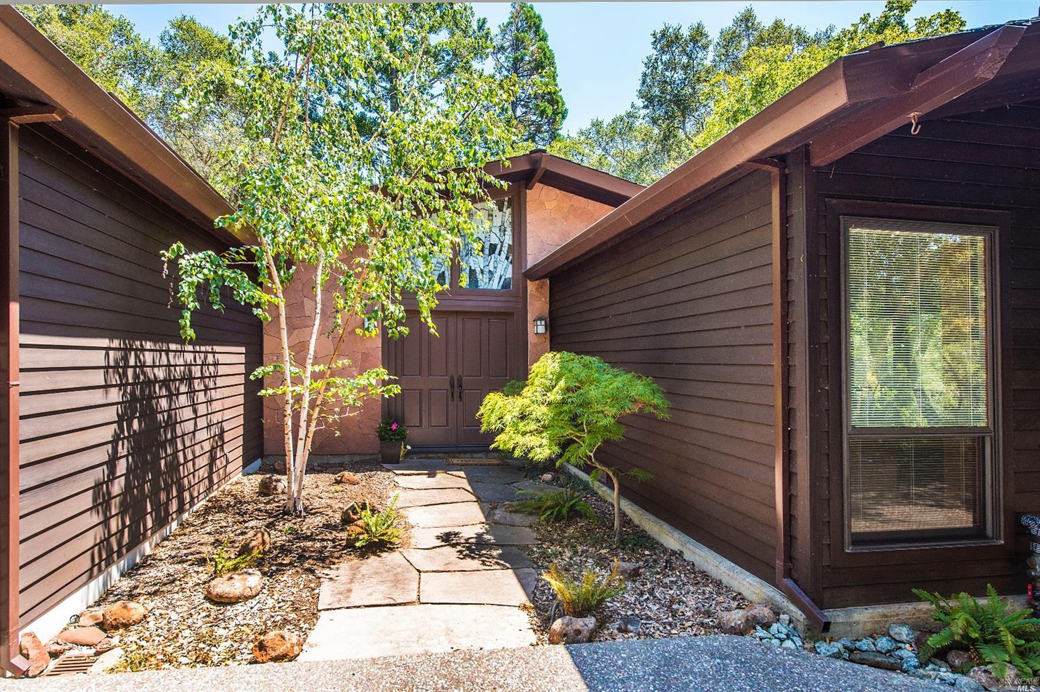22 Canyon Road Ross, CA 94957 - Photo 1 of 1 a view of a backyard with chair and flower plants