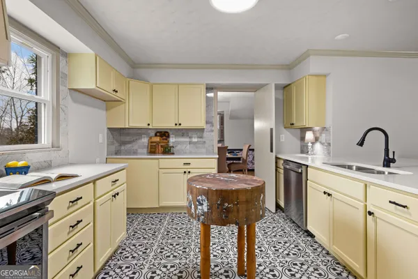 a kitchen with a sink stove and cabinets