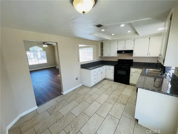 a kitchen with stainless steel appliances granite countertop a sink and cabinets