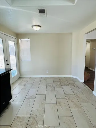 a view of an empty room and a window