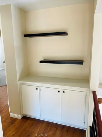 an empty room with fan and entrance