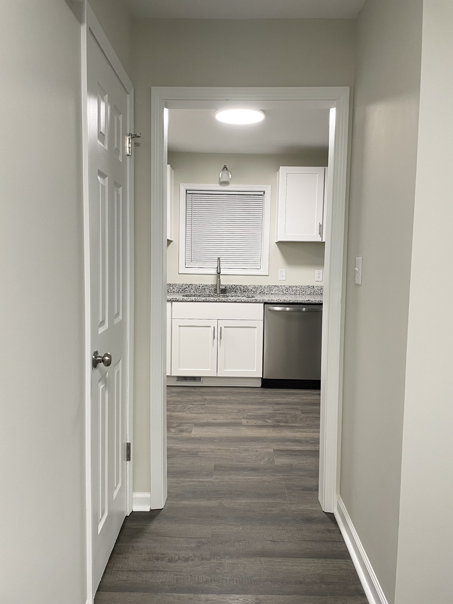 3060 Lylewood Road Woodlawn, TN 37191 - Photo 4 of 56 a view of a kitchen from the hallway with a sink and wooden floor