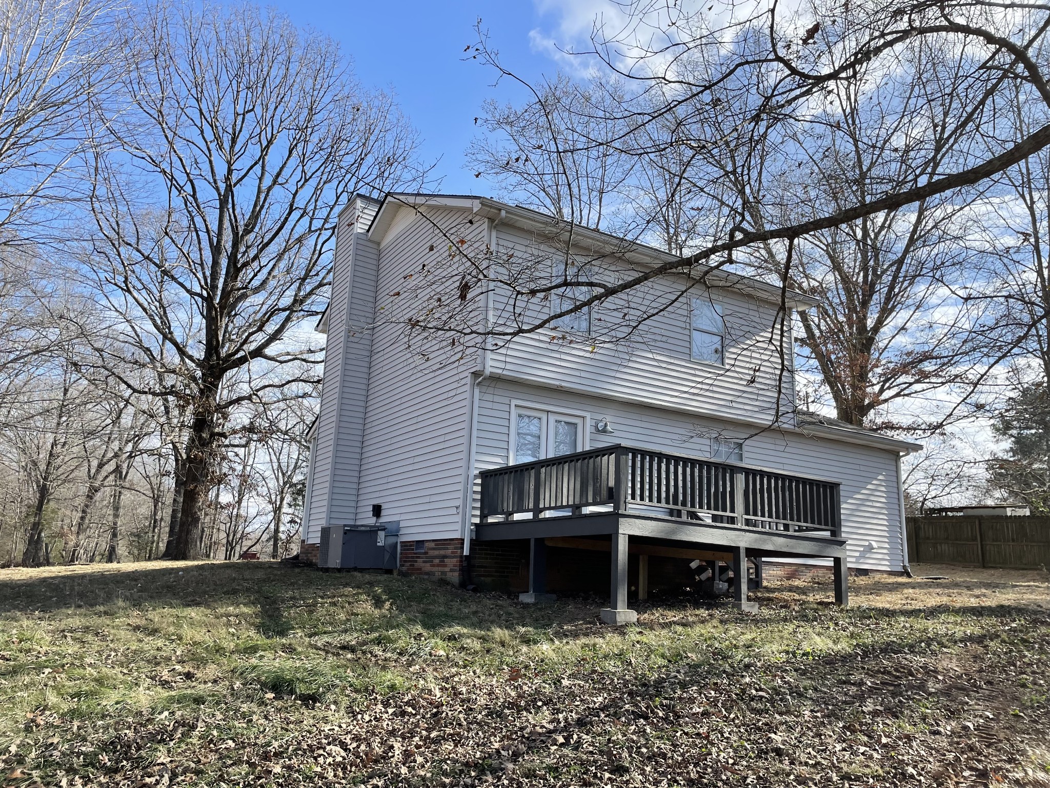 3060 Lylewood Road Woodlawn, TN 37191 - Photo 42 of 56 a view of a house with a large tree and a wooden fence