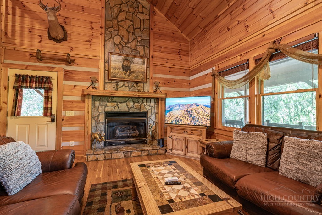 197 Woodby Ridge Road Vilas, NC 28692 - Photo 6 of 45 a living room with furniture a fireplace and a large window