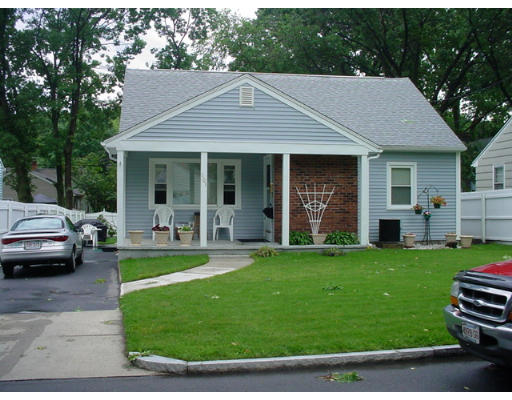 a front view of a house with a garden and porch