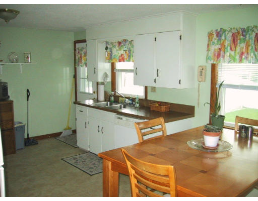 107 Huron Street Springfield, MA 01104 - Photo 3 of 14 a kitchen with a table chairs and a stove