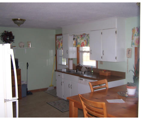 107 Huron Street Springfield, MA 01104 - Photo 4 of 14 a kitchen with granite countertop a sink and a refrigerator
