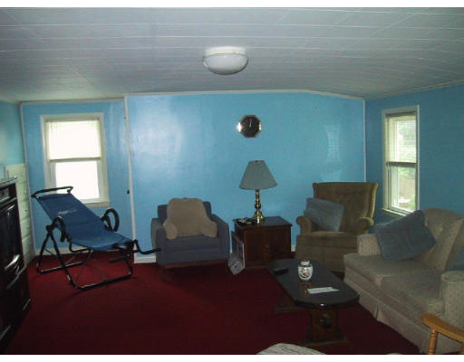 107 Huron Street Springfield, MA 01104 - Photo 7 of 14 a living room with furniture and a lamp