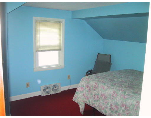 107 Huron Street Springfield, MA 01104 - Photo 8 of 14 a bedroom with a bed and a window