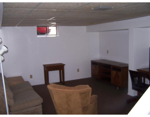 107 Huron Street Springfield, MA 01104 - Photo 9 of 14 a room with furniture and a chair