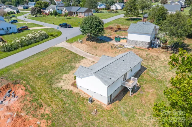 an aerial view of a house with yard swimming pool and outdoor seating