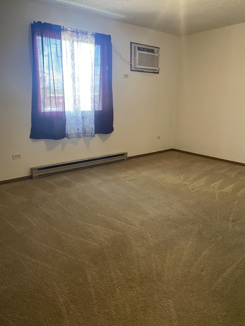 216 Madison Street, Unit 3D Joliet, IL 60435 - Photo 6 of 6 a view of an empty room and window