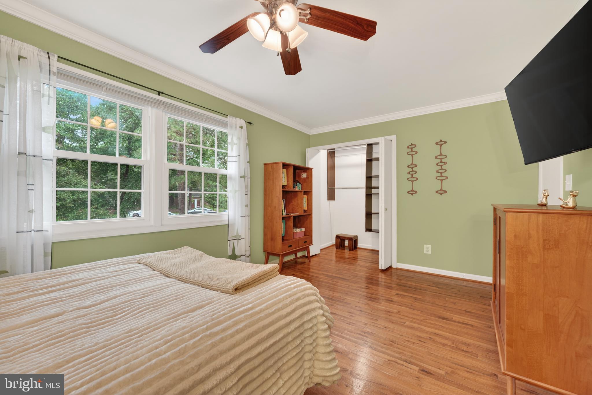 8139 Carrleigh Parkway Springfield, VA 22152 - Photo 24 of 27 a bedroom with a bed and a flat screen tv