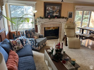 983 Grindelwald Lane, Unit O4 Midway, UT 84049 - Photo 6 of 14 Living area featuring a fireplace with a tile surround and decorative mantelpiece, large window, and sliding glass door