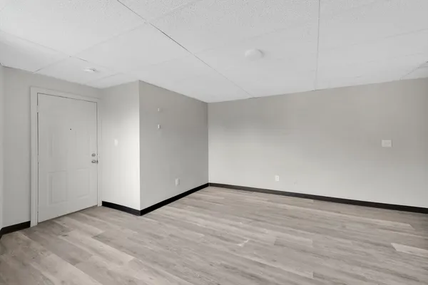 a view of an empty room and wooden floor