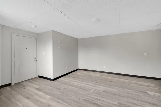 a view of an empty room and wooden floor