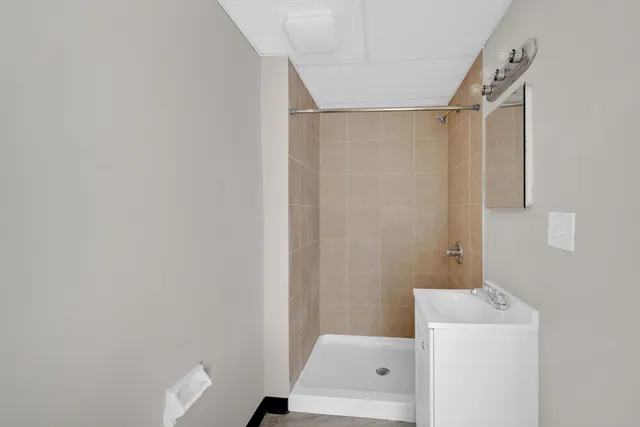 a bathroom with a shower and a sink