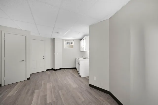 a view of a room with wooden floor and white doors