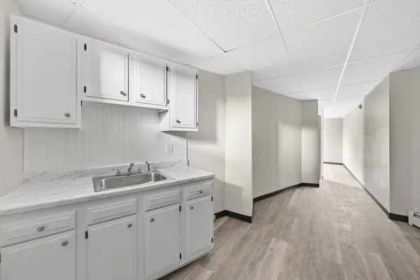 a kitchen with sink cabinets and wooden floor