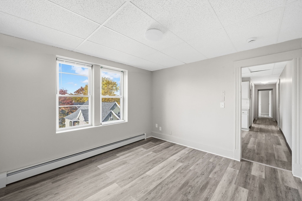 192-198 White Street Springfield, MA 01108 - Photo 7 of 29 an empty room with wooden floor and windows