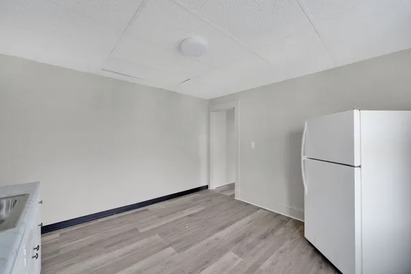 a view of a refrigerator in kitchen and wooden floor