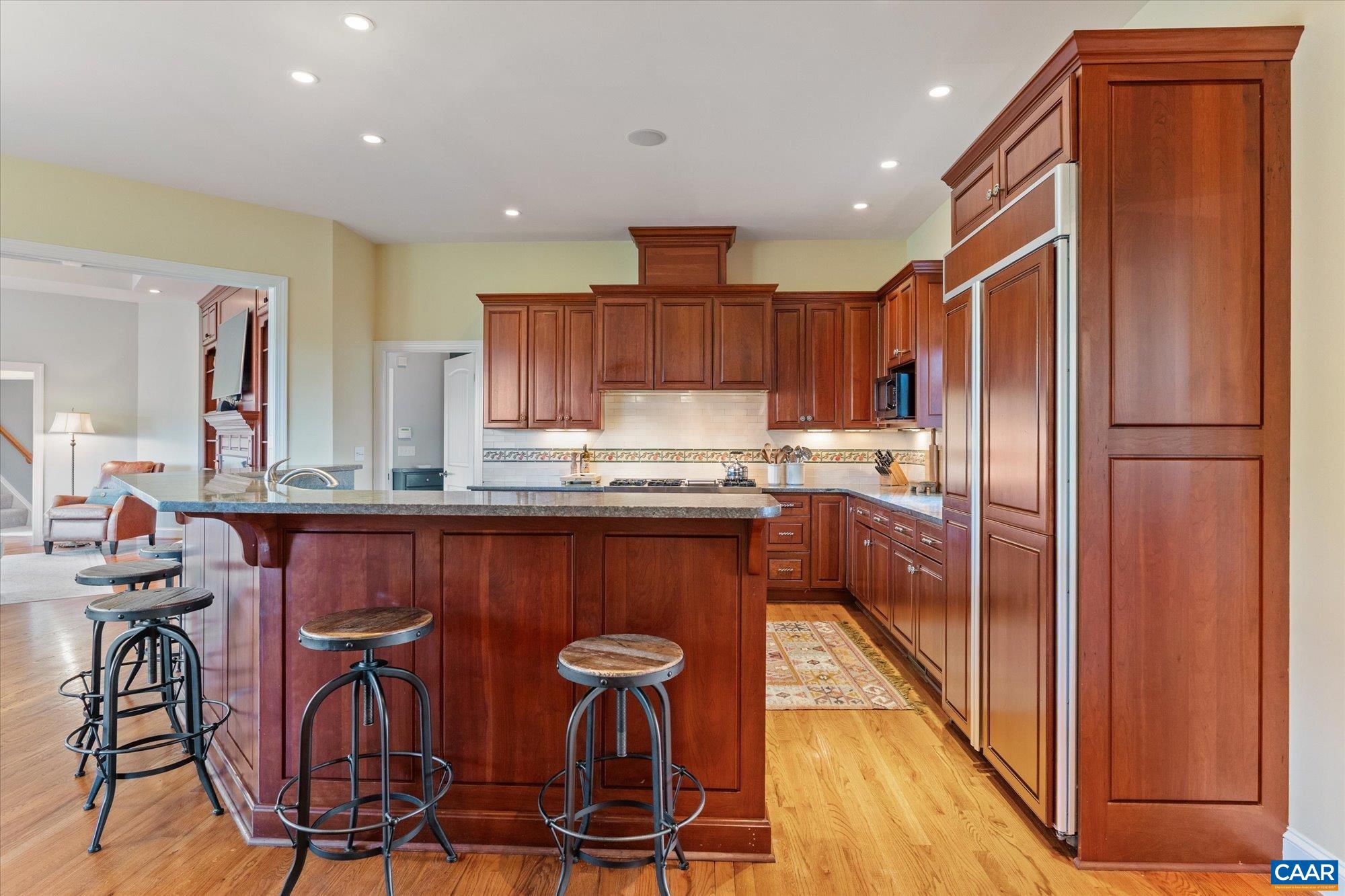 3150 Rocks Farm Court Charlottesville, VA 22903 - Photo 21 of 74 a kitchen with stainless steel appliances granite countertop a refrigerator a sink a stove a dining table and chairs