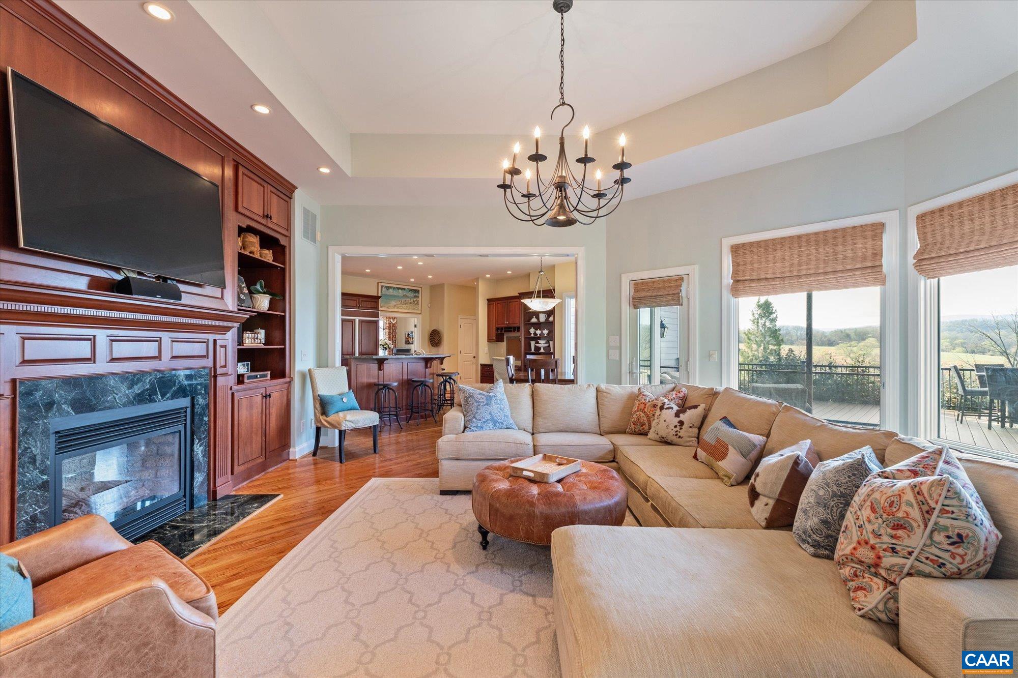 3150 Rocks Farm Court Charlottesville, VA 22903 - Photo 31 of 74 a living room with furniture a flat screen tv and a fireplace