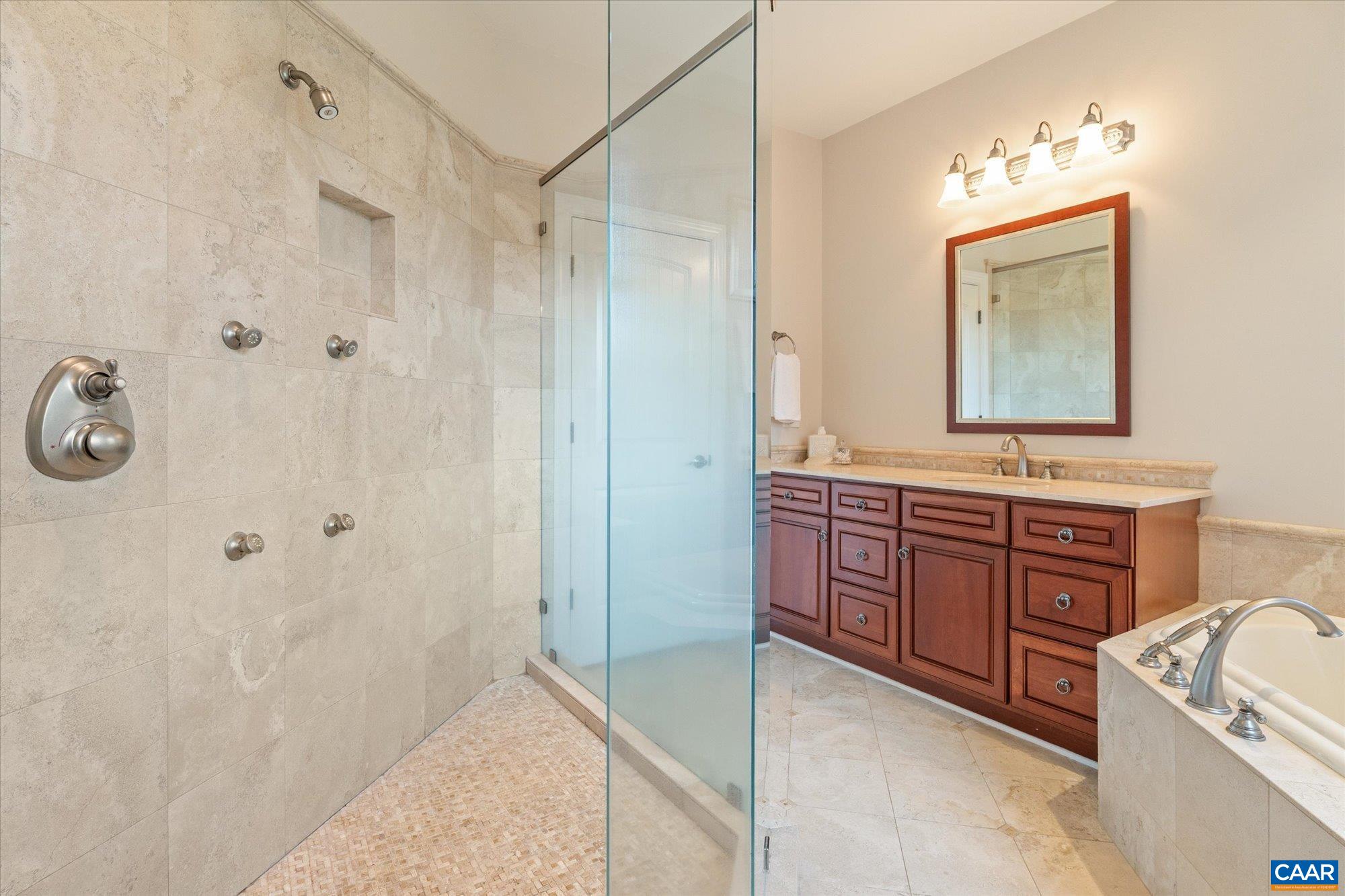 3150 Rocks Farm Court Charlottesville, VA 22903 - Photo 48 of 74 a bathroom with a granite countertop sink a mirror a shower and a bathtub