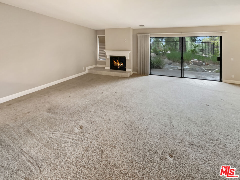 300 South Prospectors Road, Unit 26 Diamond Bar, CA 91765 - Photo 5 of 19 an empty room with fireplace and large window