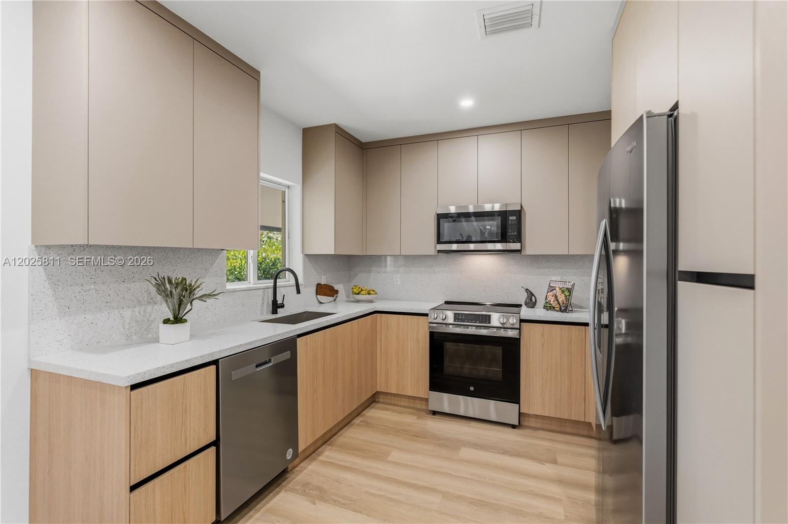 2110 Southwest 15th Street Miami, FL 33145 - Photo 11 of 37 a kitchen with stainless steel appliances granite countertop a stove top oven a refrigerator and a sink