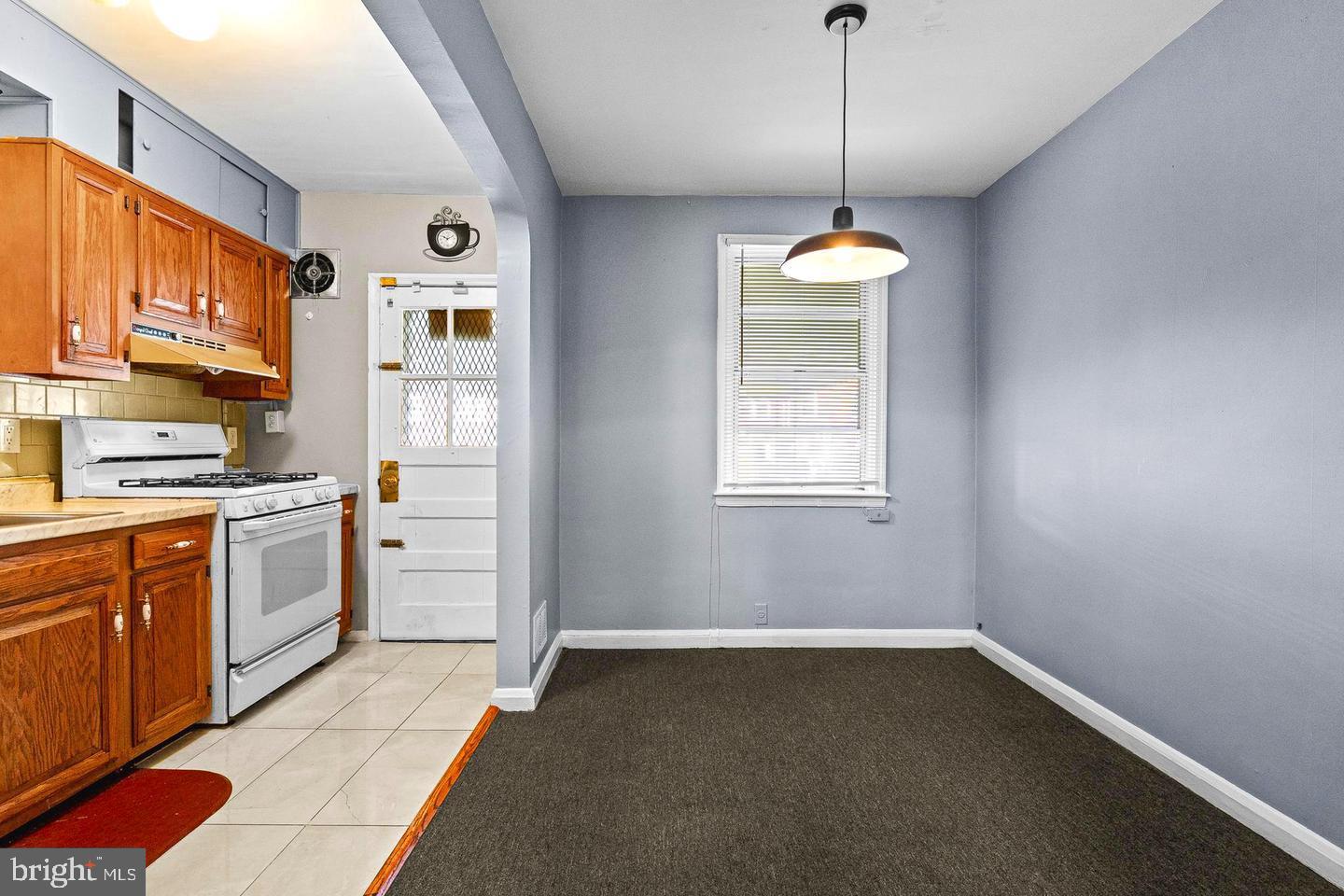 1300 North Potomac Street Baltimore, MD 21213 - Photo 4 of 20 a kitchen with refrigerator and window