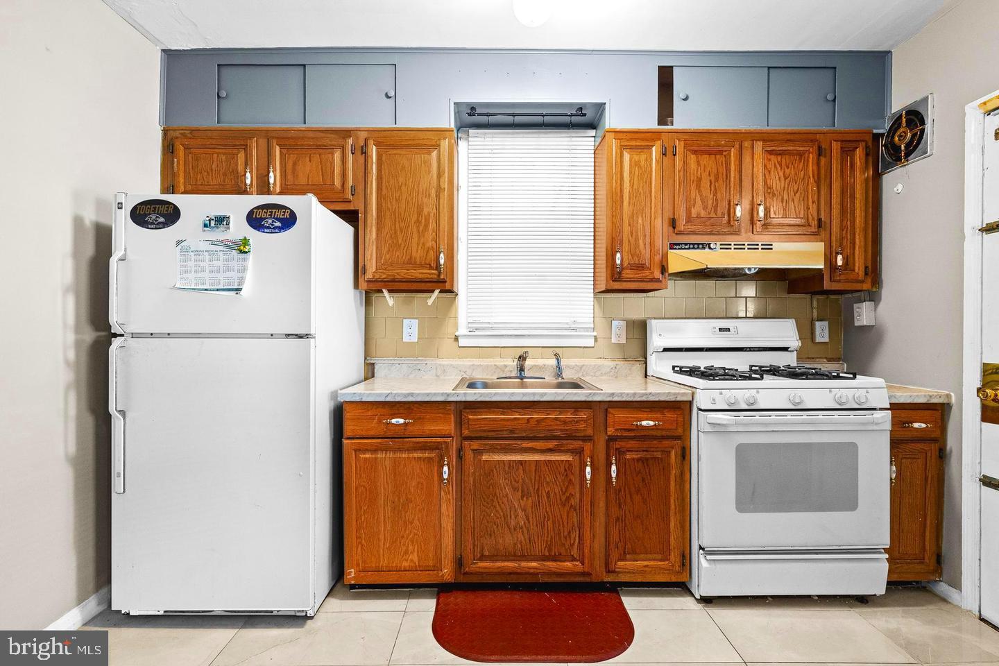 1300 North Potomac Street Baltimore, MD 21213 - Photo 5 of 20 a kitchen with a refrigerator and a stove